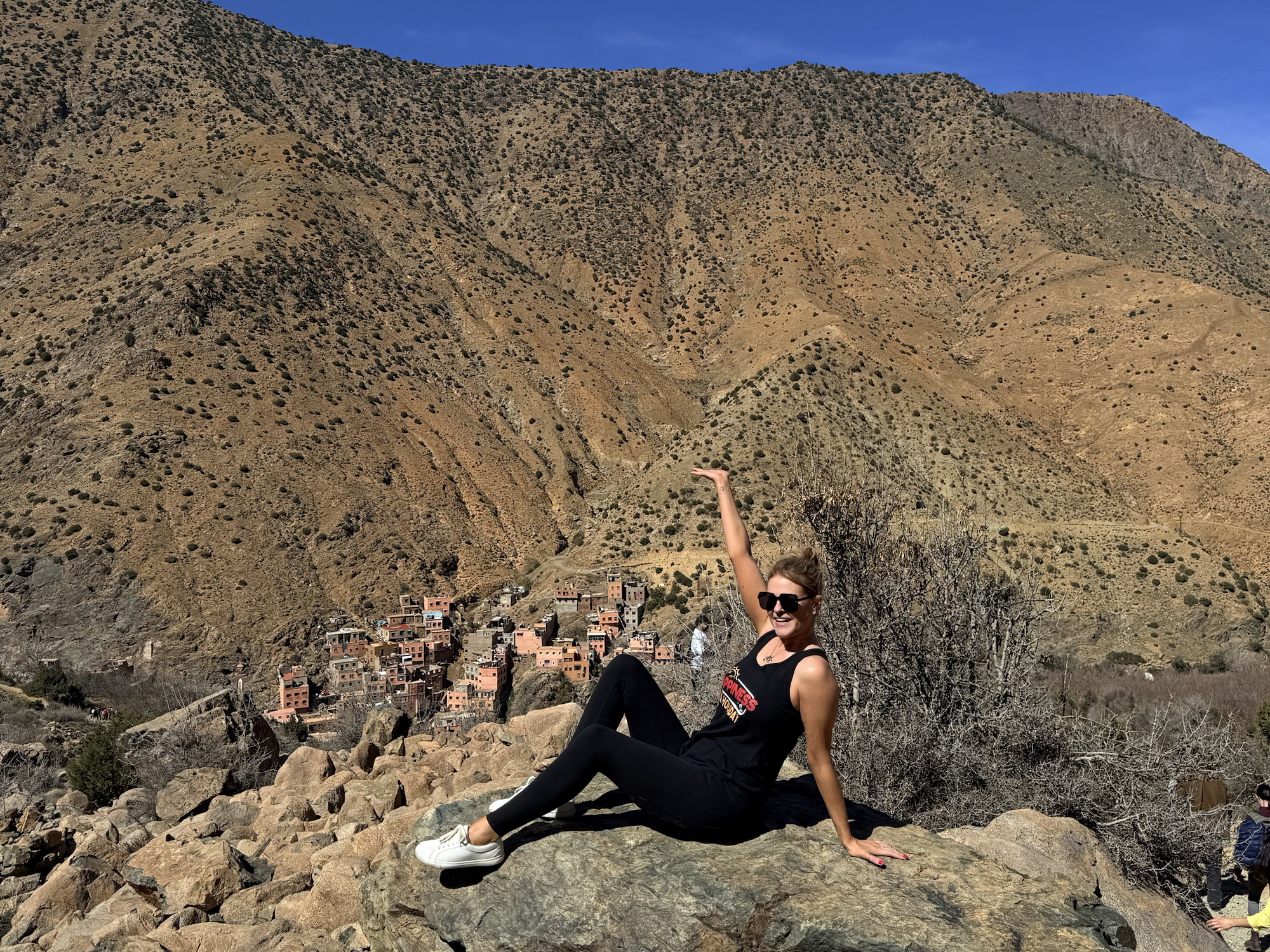 Woman in black on a rock high up in the Atlas mountains 
